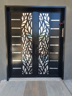 an iron door with decorative glass panels on it