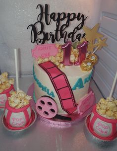 a birthday cake with pink and white decorations