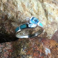 This beautiful Sterling Silver Ring Set, as part of the Arizona Blue Collection features Kingman Turquoise with a Blue Topaz. Engagement Ring Width: Top 5/8"; Shank 1/8" Band Width: 1/4"; Shank 1/8" The ring is designed by David Rosales, one of the finest contemporary Southwest Artists in the world. He is the founder and co-owner of Supersmiths, Inc. of Gallup, NM. Each ring is custom made and carries a lifetime guarantee. Turquoise Sterling Silver Jewelry With Center Stone, Blue Turquoise Gemstone Ring, Blue Turquoise Gemstone Ring Fine Jewelry, Blue Turquoise Gemstone Ring In Fine Jewelry Style, Sterling Silver Turquoise Ring With Gemstone Accents, Blue Turquoise Ring With Gemstone Accents In Sterling Silver, Blue Opal Ring With Inlay For Anniversary, Blue Opal Inlay Ring For Anniversary, Anniversary Blue Opal Ring With Inlay