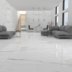 a living room filled with lots of furniture and white marble flooring next to tall windows