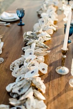 the table is covered with shells and candles