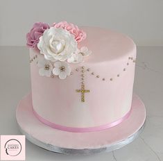 a pink and white cake with flowers on top