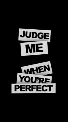 the words judge me and when you're perfect are cut out from white paper