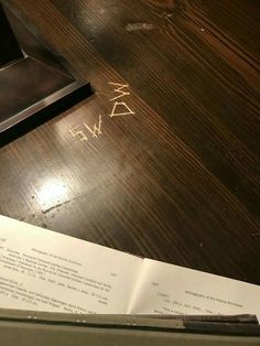 a piece of paper sitting on top of a wooden table