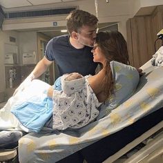 a man standing next to a woman in a hospital bed