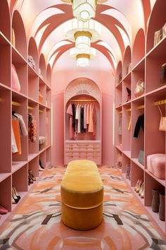 a walk in closet filled with lots of pink and yellow items, including an ottoman