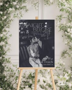 the night before book cover on an easel surrounded by white flowers and greenery