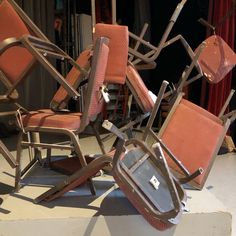 a pile of chairs sitting on top of a floor