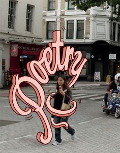 a woman walking across a street holding a cell phone