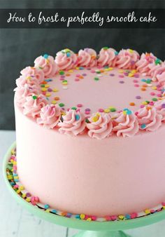 a pink frosted cake with sprinkles is on a green plate and has the words how to frost a perfectly smooth cake