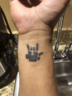 a person with a small tattoo on their wrist