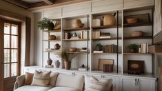 a living room filled with furniture and bookshelves