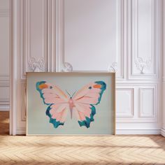 a pink and blue butterfly painting in a white room