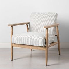 a chair sitting on top of a hard wood floor next to a white and gray wall