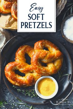 two soft pretzels on a plate with dipping sauce in the middle and an easy soft pretzel recipe