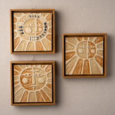 three square wooden plaques with designs on them