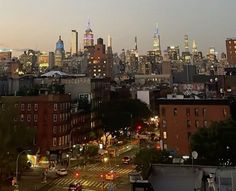 the city skyline is lit up at night with bright lights on it's buildings