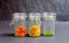 three glass jars filled with different types of food