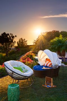 there are two lawn chairs in the grass