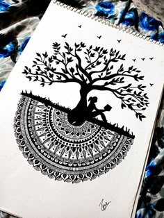 a drawing of a tree with birds flying around it on top of a sheet of paper