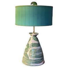 a table lamp with a green shade on it