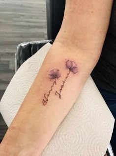 a woman's arm with three flowers on it