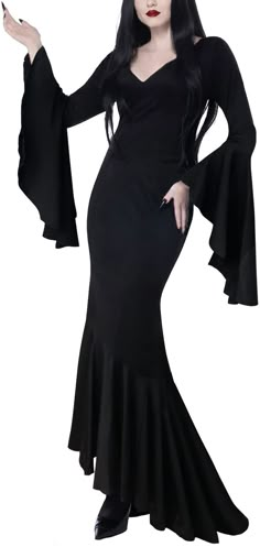 a woman dressed in black is posing for the camera