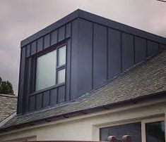 the roof of a house with a large window