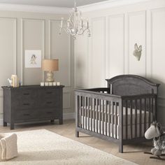 a baby's room with a crib, dressers and a teddy bear