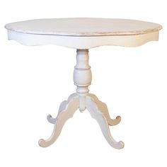 a white table with an oval wooden top