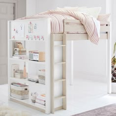 a white bunk bed sitting in a bedroom next to a book shelf and rug on the floor