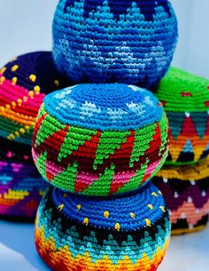 colorful baskets are stacked on top of each other in the shape of an ornament