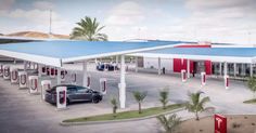 a car is parked in front of a gas station with red and white awnings