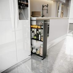 an open refrigerator in a kitchen next to a sink