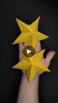 a hand holding up an origami star