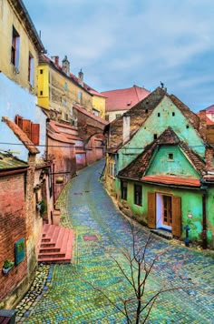 an old street with colorful buildings and cobblestones