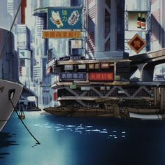 a boat floating on top of a body of water next to tall buildings in a city