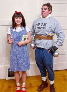 a man and woman in costumes standing next to each other