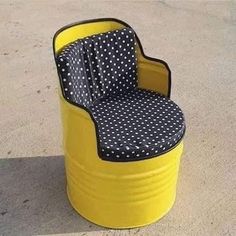 a yellow and black chair sitting on top of a cement floor