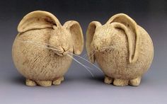 two ceramic figurines made to look like mice, one with its mouth open