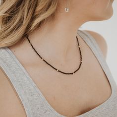 This beautiful Obsidian Beaded Necklace is edgy. elegant, and eye-catching, making it perfect for wearing by itself or layered with a simple chain necklace. The strand of pearls is punctuated with your choice of gold or silver beads for added interest. Note: We reinforce the necklace’s center silk cord with hidden knots—if your necklace breaks, most of the beads will remain intact and unaffected. For maximum life, we recommend you do not wear this necklace in water or during any rigorous activities. Details: 3mm Black Obsidian gemstone beads Silk center cord Gold fill or sterling silver clasps Extendable up to 2-inches Hidden knots every 1.5-inches for added durability Should not be worn in water or for rigorous activities Birthstone Jewelry Mothers, Strand Of Pearls, Simple Chain Necklace, Chain Layering, Simple Chain, Fidget Rings, Rings Fashion, Forever Jewelry, Silk Cord