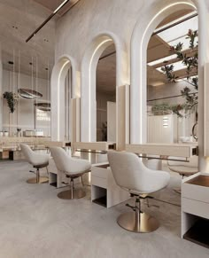 the interior of a hair salon with white chairs and large mirrors on the wall above them