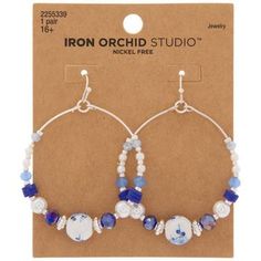 Details: 	 Dimensions: 2.38" H x 1.75" W x 0.38" D 	 Type: Ear Wire 	 Material: Metal & Plastic 	 Color: Blue & White 	 Metal Color: Silver 	 Quantity: 1 Pair Deck yourself out with some timeless style! It's easy when you have these Blue & White Beaded Hoop Earrings. These hoop earrings have a bottom half decorated with plastic pearls and translucent blue beads. The color scheme adds to a delicate aesthetic that you'll love to wear out! Diy Earrings Dangle, Delicate Aesthetic, Making Jewelry For Beginners, Diy Jewelry Making Tutorials, Beaded Jewelry Earrings, Homemade Earrings, Wire Wrap Jewelry Designs, Paired Jewelry, Beaded Earrings Diy