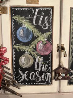 chalkboard with ornaments hanging on the front door