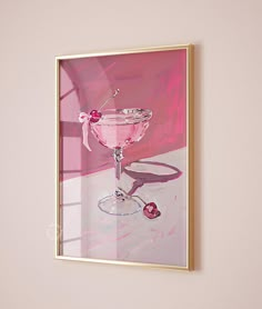 a painting of a pink martini in a gold frame