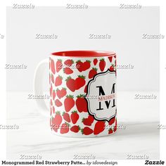 a red and white mug with strawberries on it