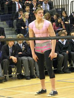 a woman standing in front of a volleyball net