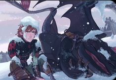 a man sitting in the snow next to a dragon