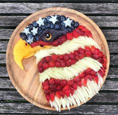 a cake made to look like an american flag eagle with berries on the bottom and sides