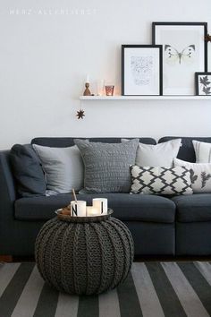 a living room filled with furniture and pictures on the wall